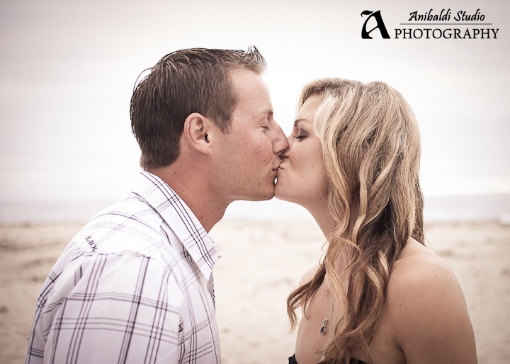 engaged couple kissing