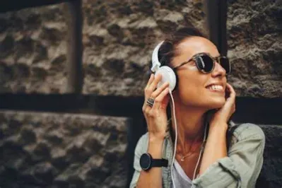 Person enjoying music on Apple Music. How To Get Apple Music Free Forever
