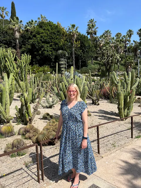 In front of a range of cactus plants in Barcelona's Jardines de Mossèn Costa i Llobera