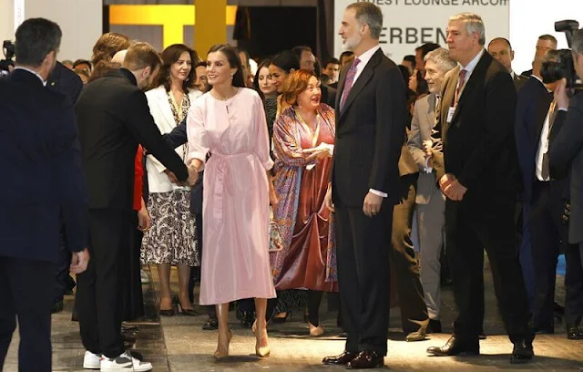 Queen Letizia wore a new rose midi shirt dress by Moises Nieto. Cashfana Babidi earrings. Furla floral pattern mini handbag