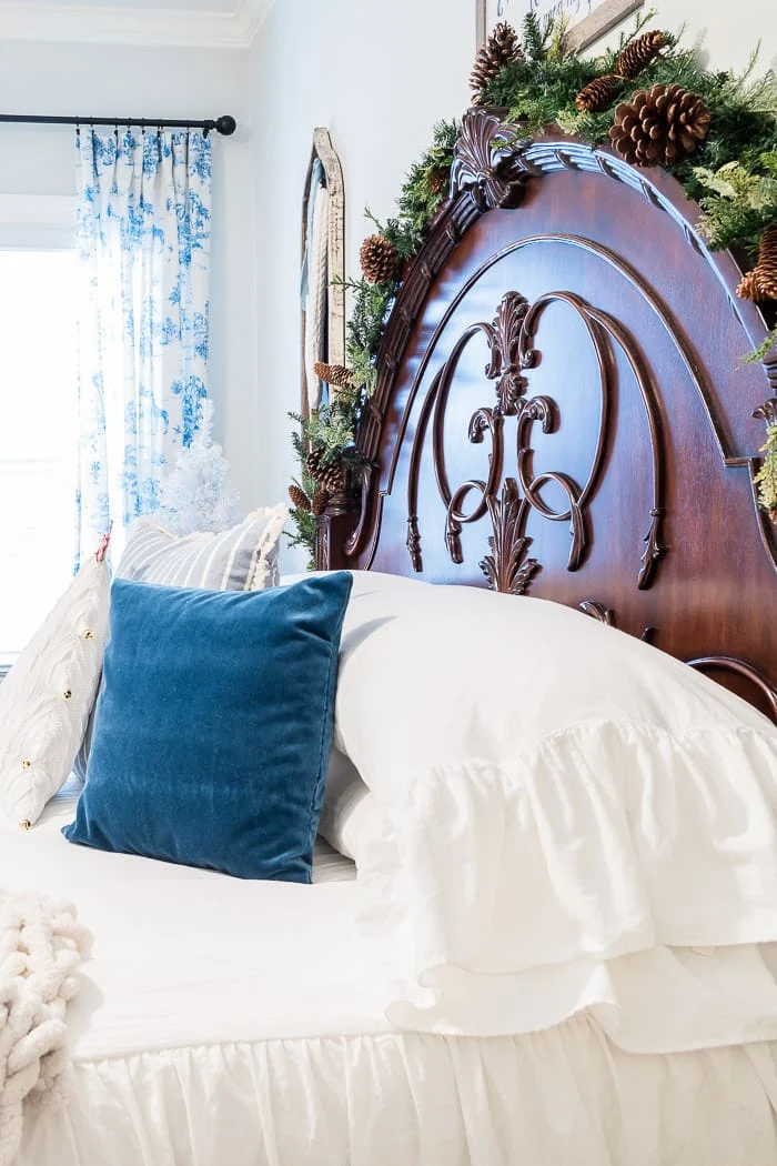 mansion headboard, garland, velvet pillows, blue toile curtains