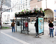 Bus Stop Bonnets for Easter. I know it's an ad and they're fake flowers, . (chicago bus stop llilies flowers easter)