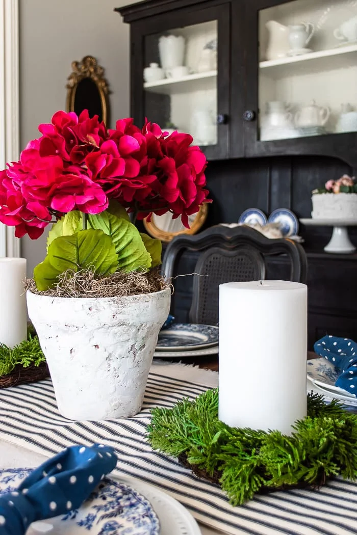 pink centerpiece on blue and white table