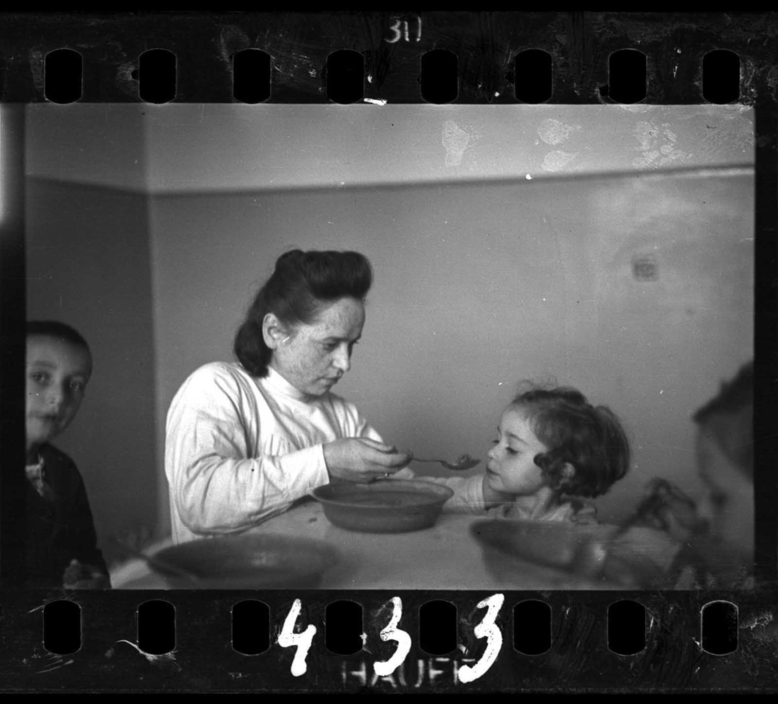 A nurse feeding children in an orphanage.