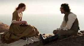 Ross and Demelza Poldark sitting together in the 'I belong here' season 1 scene