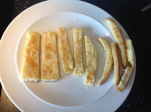 Plate with slice of eggy bread cut into fingers, and the crusts cut off