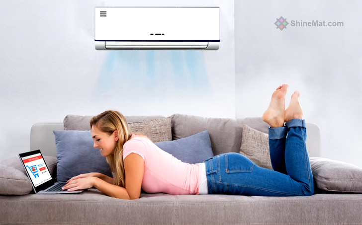 Woman Using Laptop Under The Air Conditioner