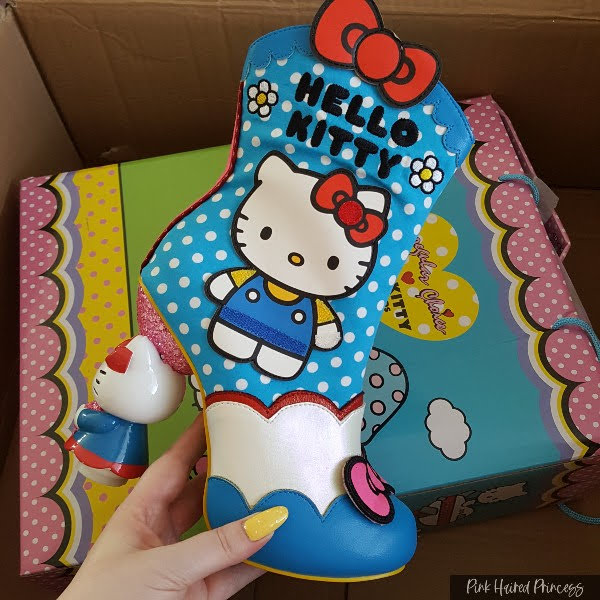 blue spotty Hello Kitty themed ankle boot held in hand