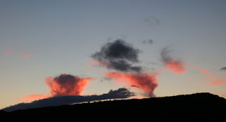 Erupting clouds above the setting sun