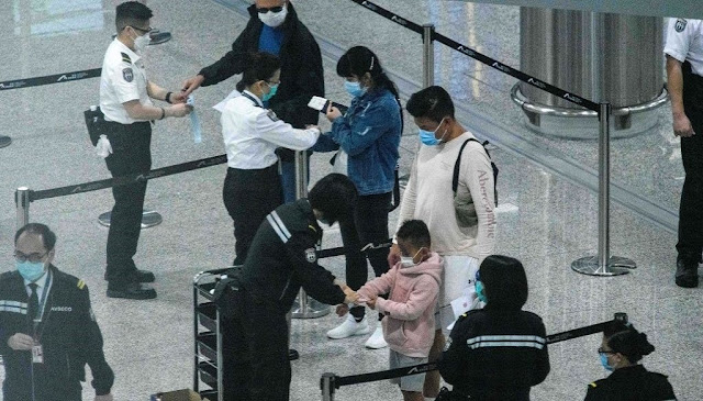 Người nhập cảnh vào Hong Kong phải đeo vòng tay định vị. Ảnh: China Daily.