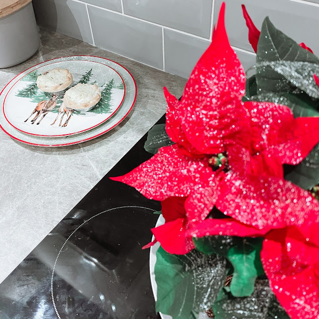 A Christmas poinsettia, Christmas plates with two mince pies on top