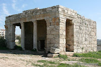 The temple-like facade is of classical style, with two pillars in the center and two elaborate mezuzahs on the sides.