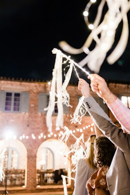 Wedding guests holding white streamers