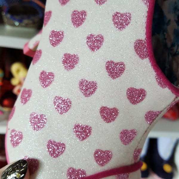 close up of pink glitter heart print on boots