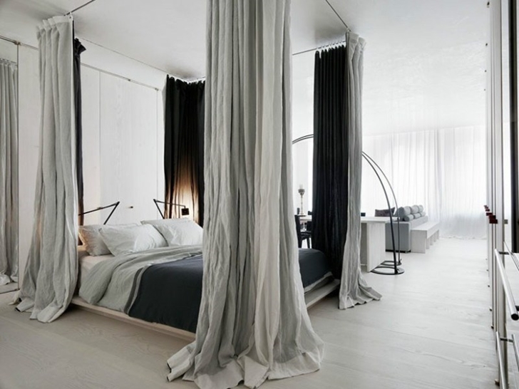 King sized bed in small apartment in New York by Rick Joy
