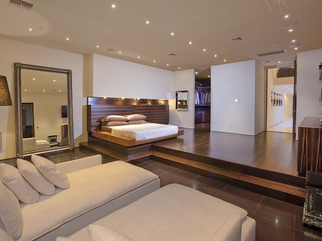 Photo of huge amazing bedroom interiors with king sized bed on the elevated surface