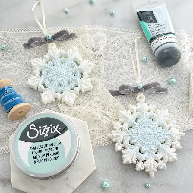 DIY Christmas ornament snowflakes created with the Redesign with Prima Wonder Spark snowflake moulds, Sizzix Creamy Matte Effects Arctic Sky Paint, Pearlescent Paste; and Prima Marketing Finnabair glitter.