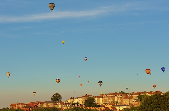 Balloons flying above Bristol's colourful houses