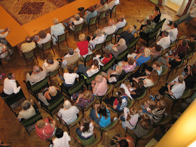 Crowd of people, sitting in a rows