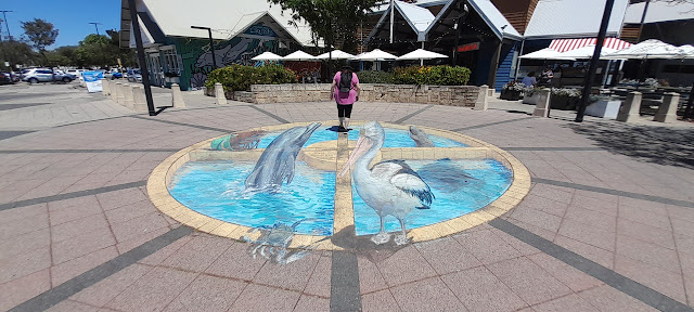 3D painting of a dolphin, pelican, sea lion, crab in or next to a pool.