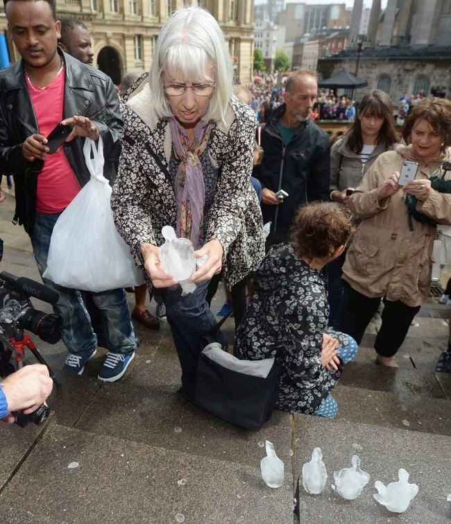 They solemnly looked on as they melted away in the sun. - To Commemorate WWI, This City Created A Powerful Temporary Ice Monument.