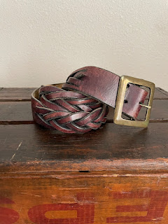 A belt sitting on a wooden box