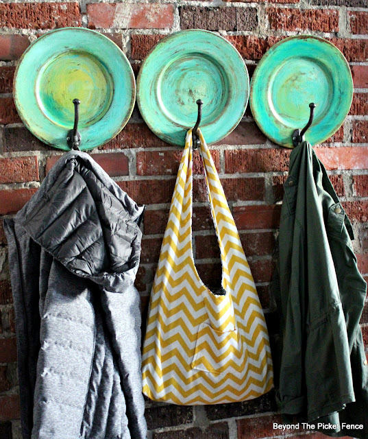 a colorful boho fun coat hook made from thrift store plates