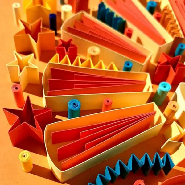 quilled on-edge design in shades of yellow, blue, and orange (detail)