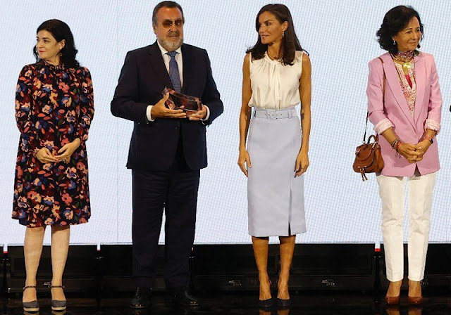 Queen Letizia wore a light blue high waisted pencil skirt by Hugo Boss, and an Iyabo ivory silk top blouse by Hugo Boss