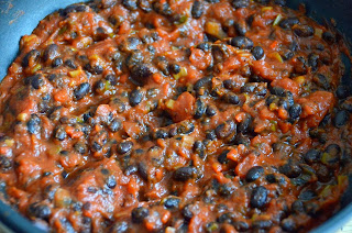 MEXICAN BAKED EGGS WITH BLACK BEANS, TOMATOES, CHILLI AND CORIANDER