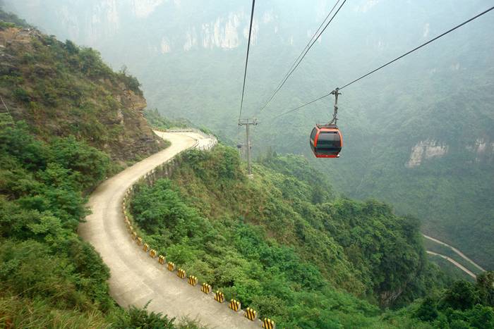 Jutting out from a sheer cliff 1,430 meters high, the glass skywalk in Zhangjiajie National Forest Park offers sightseers terrifying thrills and clear view of the mountains below as they tread nervously across the 60 meter long bridge encircling the vertical cliffs of Tianmen Mountain in Hunan province. The 3ft-wide, 2.5in thick glass walkway is so scary that sightseers are requested to wear cloth slip-ons over their shoes when they cross the skywalk, presumably to make the job easier for the cleaners.