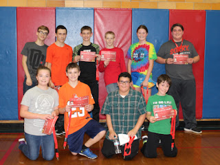 Teen boys posing for a photo holding awards for Hoops for Hearts