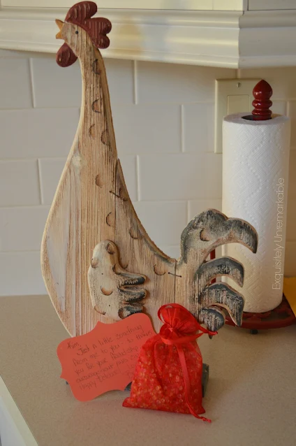 Red Wooden Chicken Carving with potpourri pouch nearby