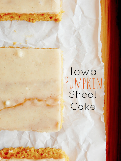 Pieces of iced pumpkin cake on parchment paper.