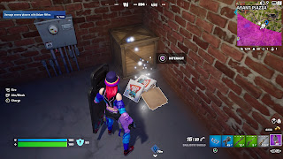 Lana Llane inspects some empty pizza boxes near the Underground HQ in Fortnite.