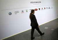 A man walks past the brands of the Volkswagen group during the annual news conference in Wolfsburg, Germany, April 28, 2016. (Credit: Reuters/Fabrizio Bensch) Click to Enlarge.