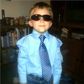 Our Grandson wearing sunglasses and a tie.