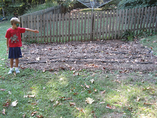 Nicholas pointing to garden