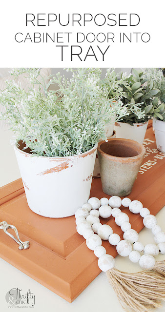 DIY spring dining table decor. DIY spring centerpiece. DIY spring tablescape. DIY faux terracotta tray. DecoArt Suede acrylic paint. DIY repurposed tray. How to make a tray out of a cabinet door. Flower Market design. Spring dining room decor.