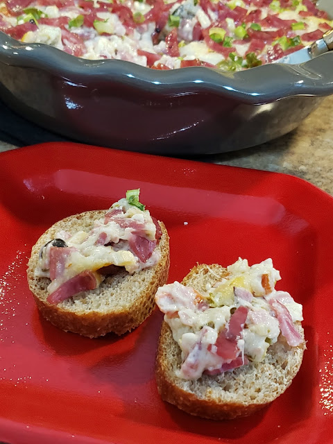 Bread slices topped with Muffaletta Dip