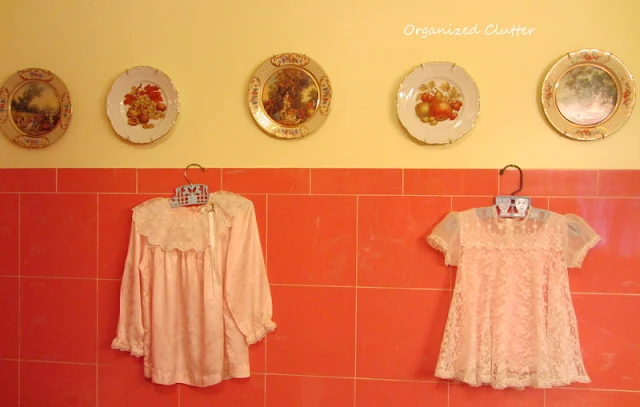 Baby dresses in a vintage bathroom