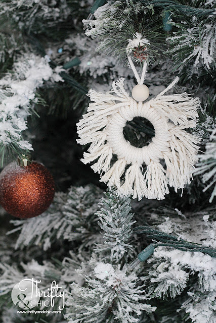 Neutral Christmas living room decor. Wood and white Christmas decor. Boho style Christmas decor. Bohemian style Christmas tree. Beaded and macrame Christmas tree decor and decorating ideas. How to decorate a Christmas tree. Farmhouse style Christmas decor. Wood and White Christmas mantel decor. Vintage Christmas mantel ideas. Flocked Christmas trees. Two story living room design.