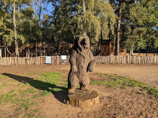 Wooden carving of a bear near the playground