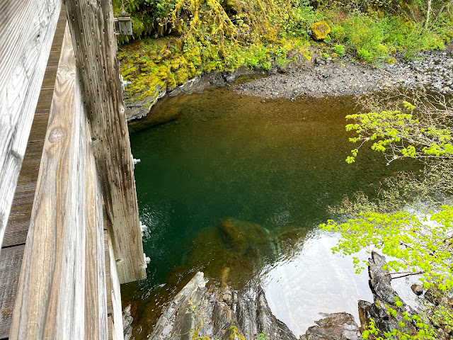 Tropical blue creek water seen from a wooden bridge