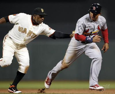 San Francisco Giants shorts stop Miguel  Tejada (L) tags out St. Louis Cardinals baserunner Jon  Jay (R) after Jay attempted to steal second base during the top of the eighth inning of their MLB National League baseball game in San Francisco, California, April 9, 2011.   REUTERS/Beck Diefenbach