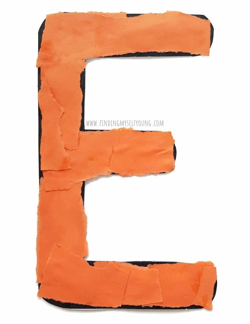 orange torn paper letter E.