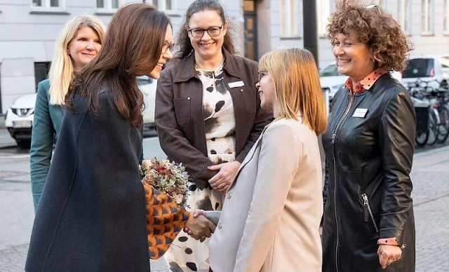 Crown Princess Mary wore a Dorit patterned blouse, shirt by Britt Sisseck, and navy blue trousers. Julie Fagerholt Heartmade cape