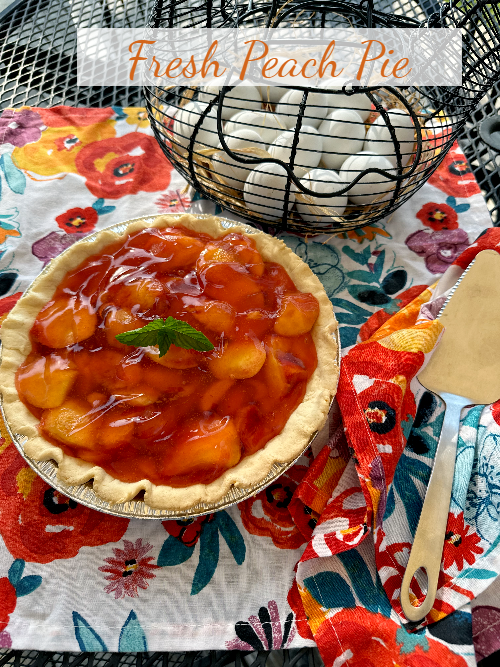 This photo shows a no bake peach pie on a table. 