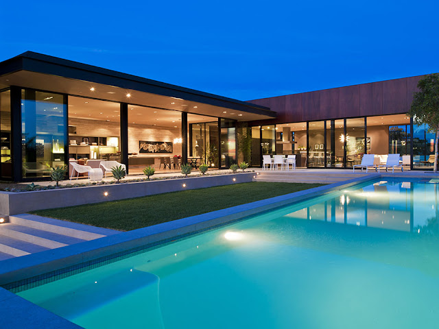 Photo of modern luxury house in Hollywood as seen from the pool at sunset