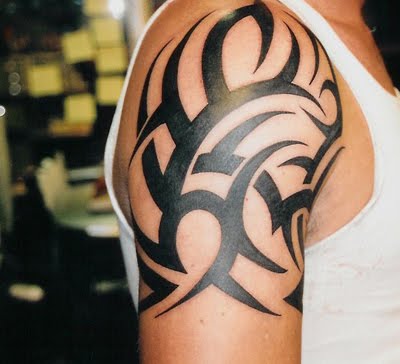 Dark bold tribal shoulder tattoo.